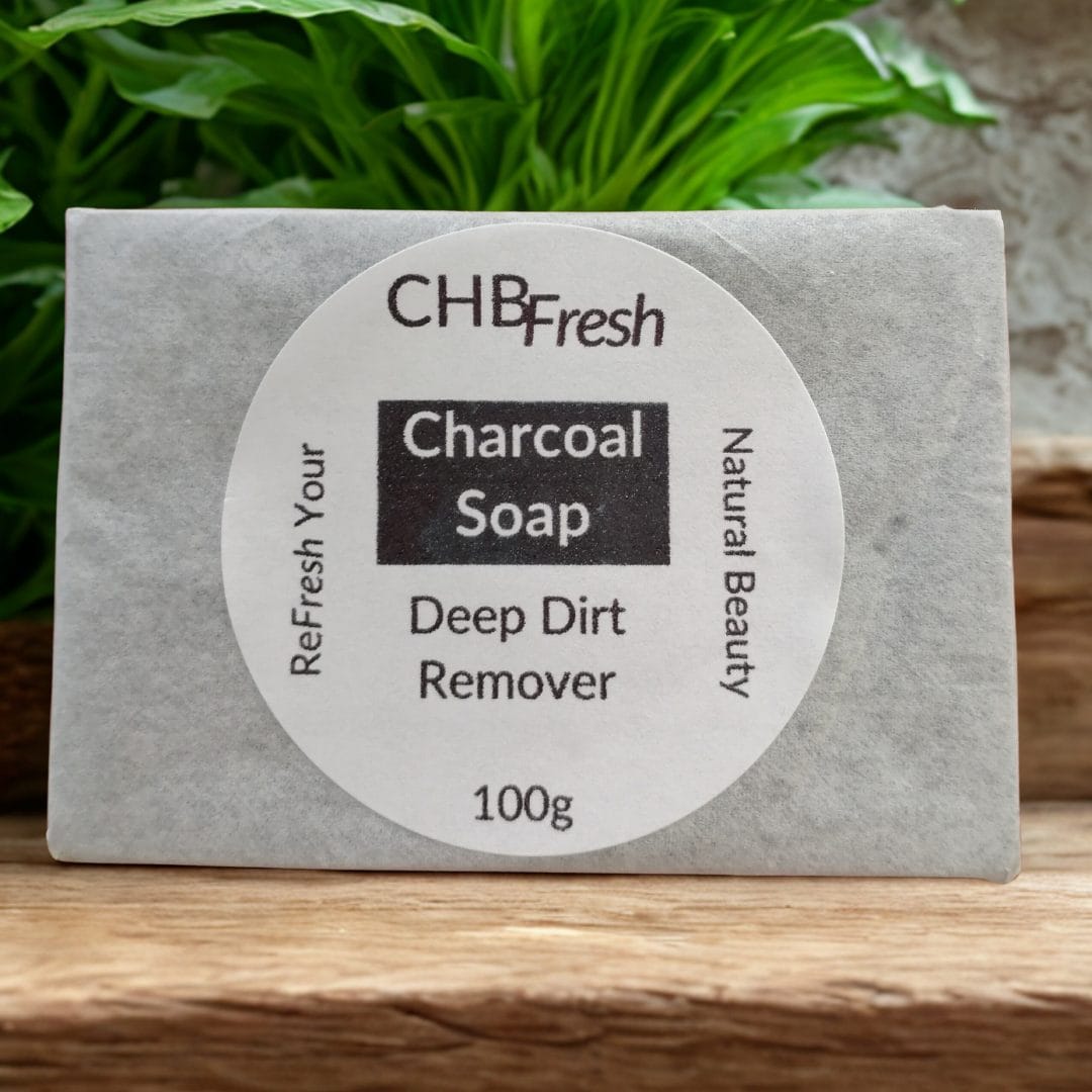 Charcoal soap on a wooden shelf with a plant