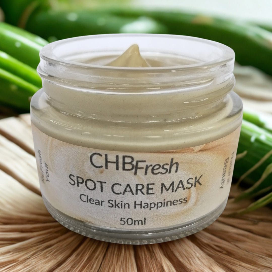 Spot Care Mask open jar on raised reed mat with aloe stalks behind it